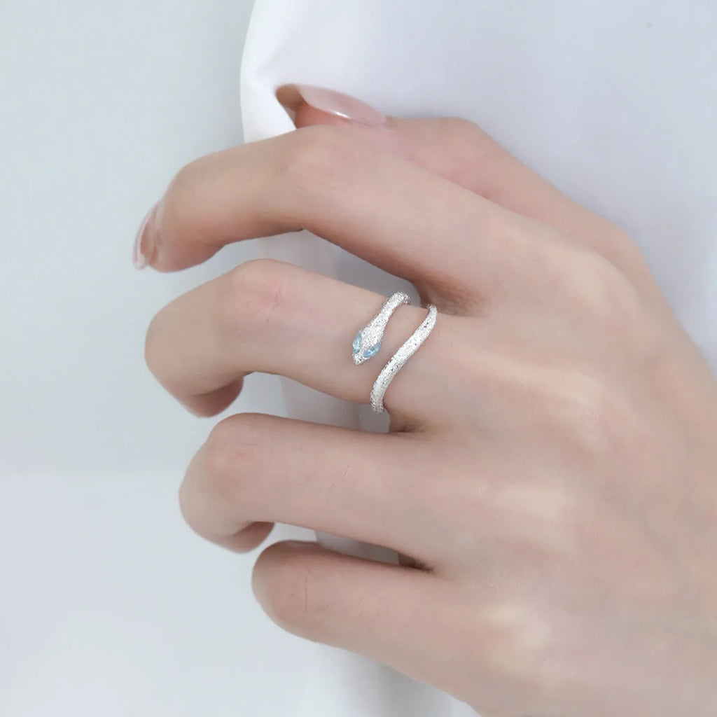 Adjustable silver snake ring with electroplated white gold finish and zodiac design