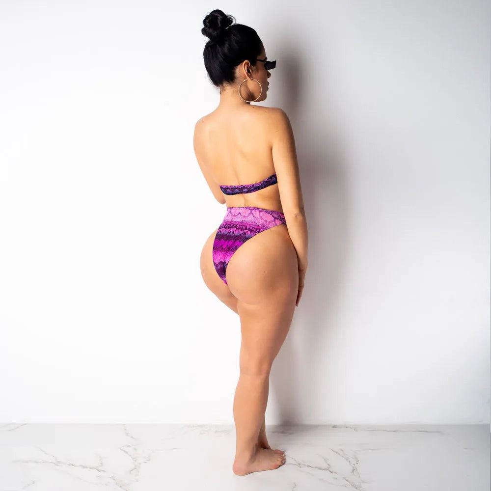 Women's purple snakeskin print bikini set with floral pattern and long sleeves.