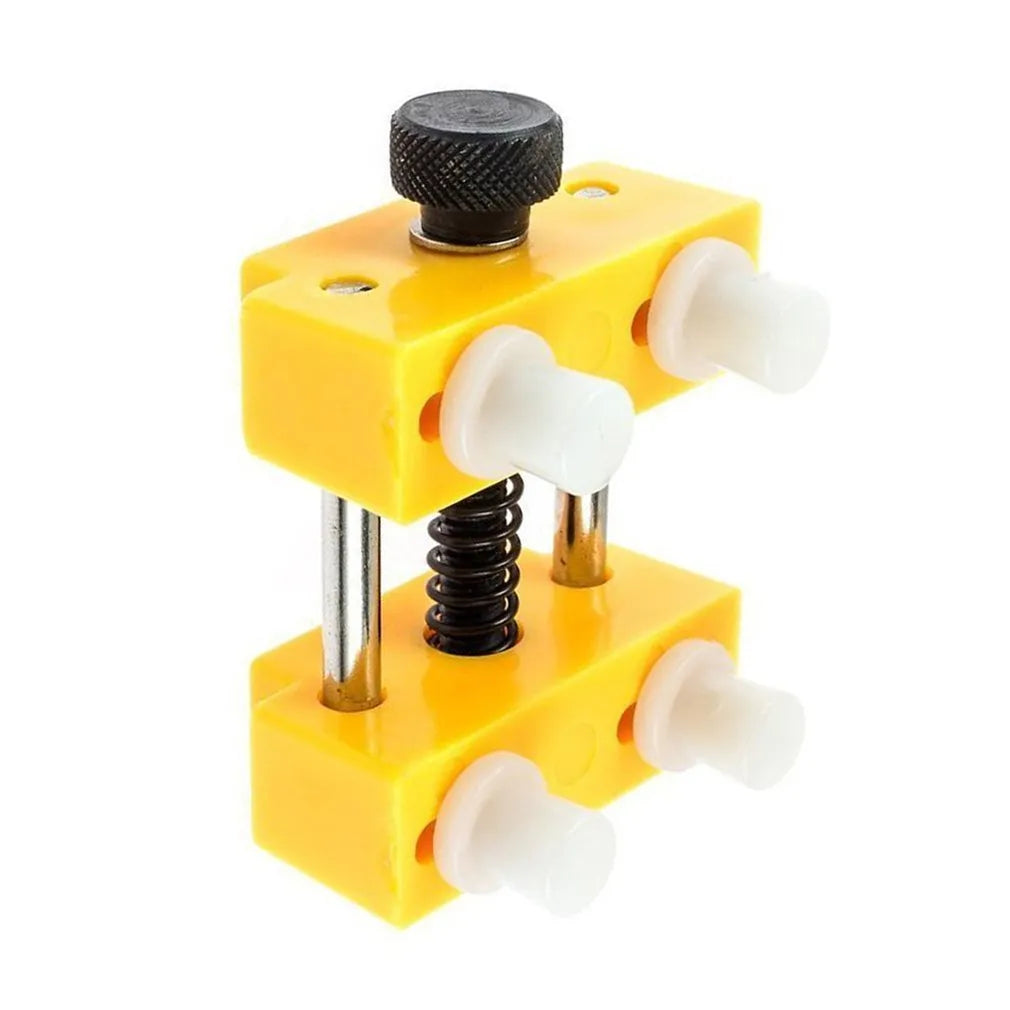 Yellow plastic watch repair case opener kit with mounting base and four positioning pillars