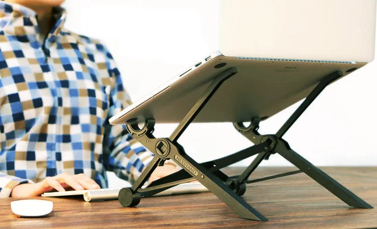 Black folding portable laptop stand made from reinforced nylon, shown folded to its compact size.