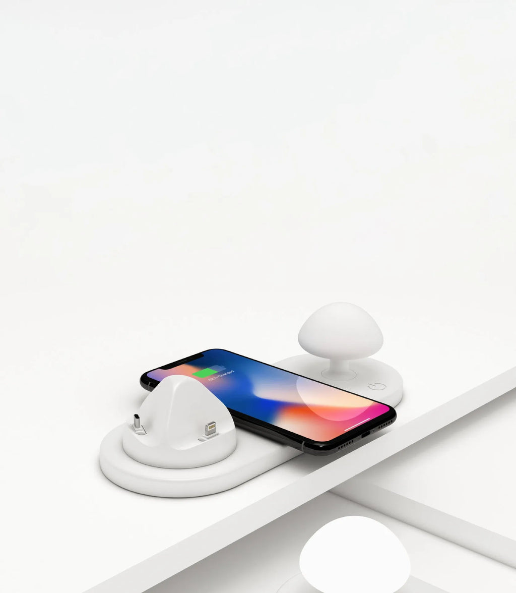 White 3 in 1 wireless charging dock with a phone on the pad and USB cable