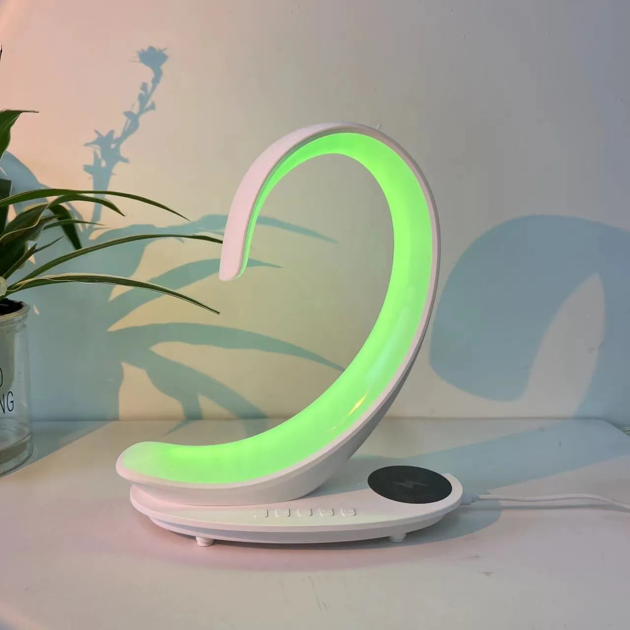 White swan shaped desk lamp with wireless charging pad, Bluetooth speaker and colourful LED lighting