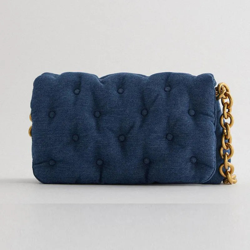 Blue oversized denim quilted shoulder bag with thick chain strap and padded buttons