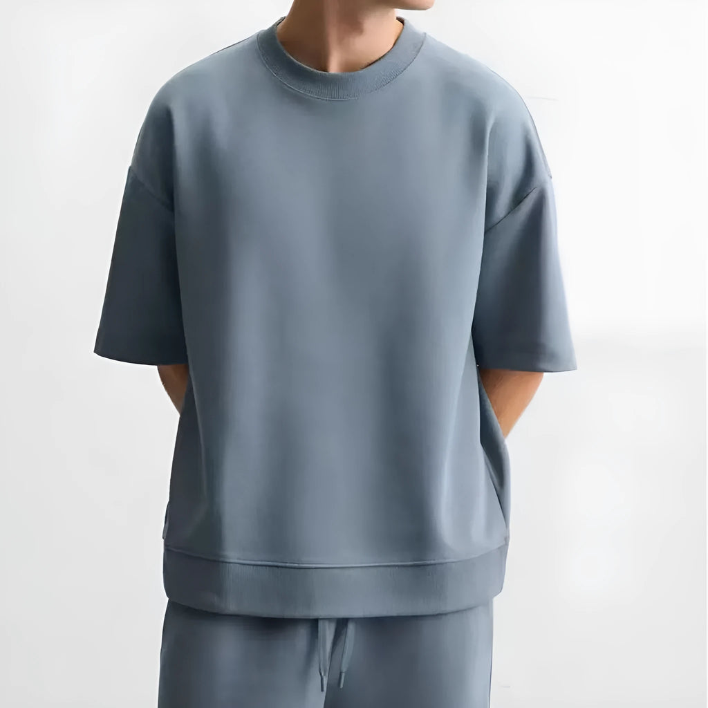 Loose fit blue polyester short sleeve T-shirt and matching shorts co-ord set on a hanger