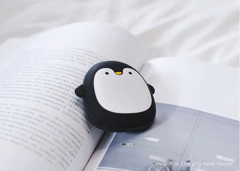 Cartoon penguin and polar bear USB rechargeable electric hand warmers showing dual-sided heating design