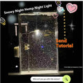 DIY snowy landscape Christmas night light with flowing snow effects and small street lamps on desktop