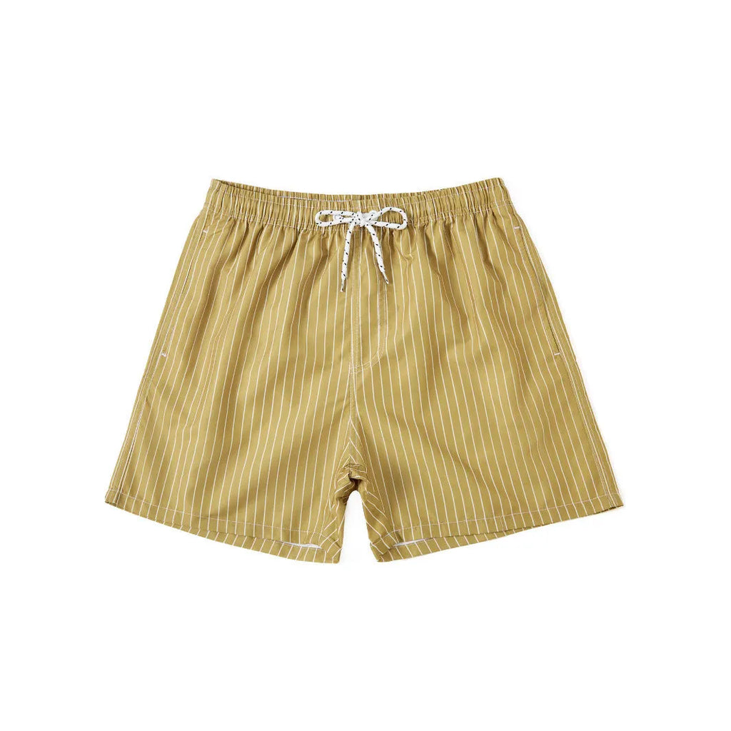 Men's striped polyester shorts in light blue, shown on a beach.