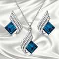 Fashion jewellery set showing alloy pendant necklace with cross chain and matching glass ear studs