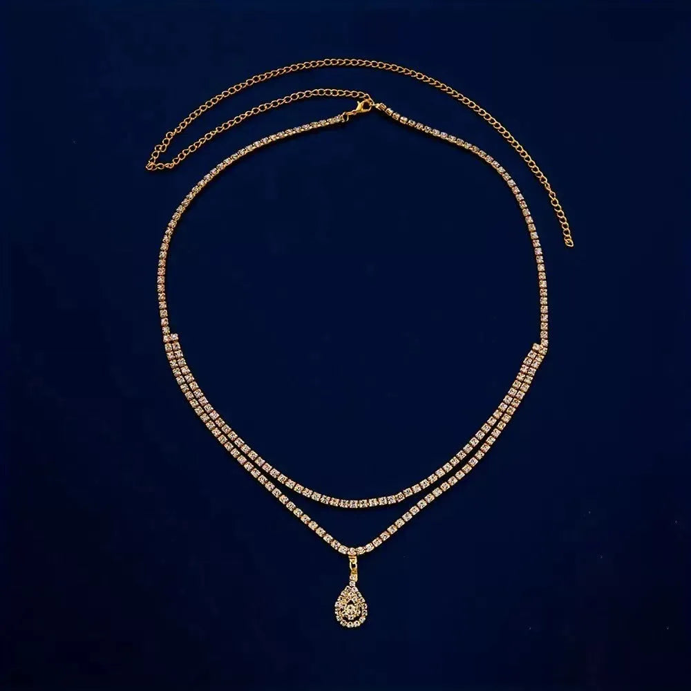 Gold or silver rhinestone waist chain with tassel detail and lobster buckle fastening