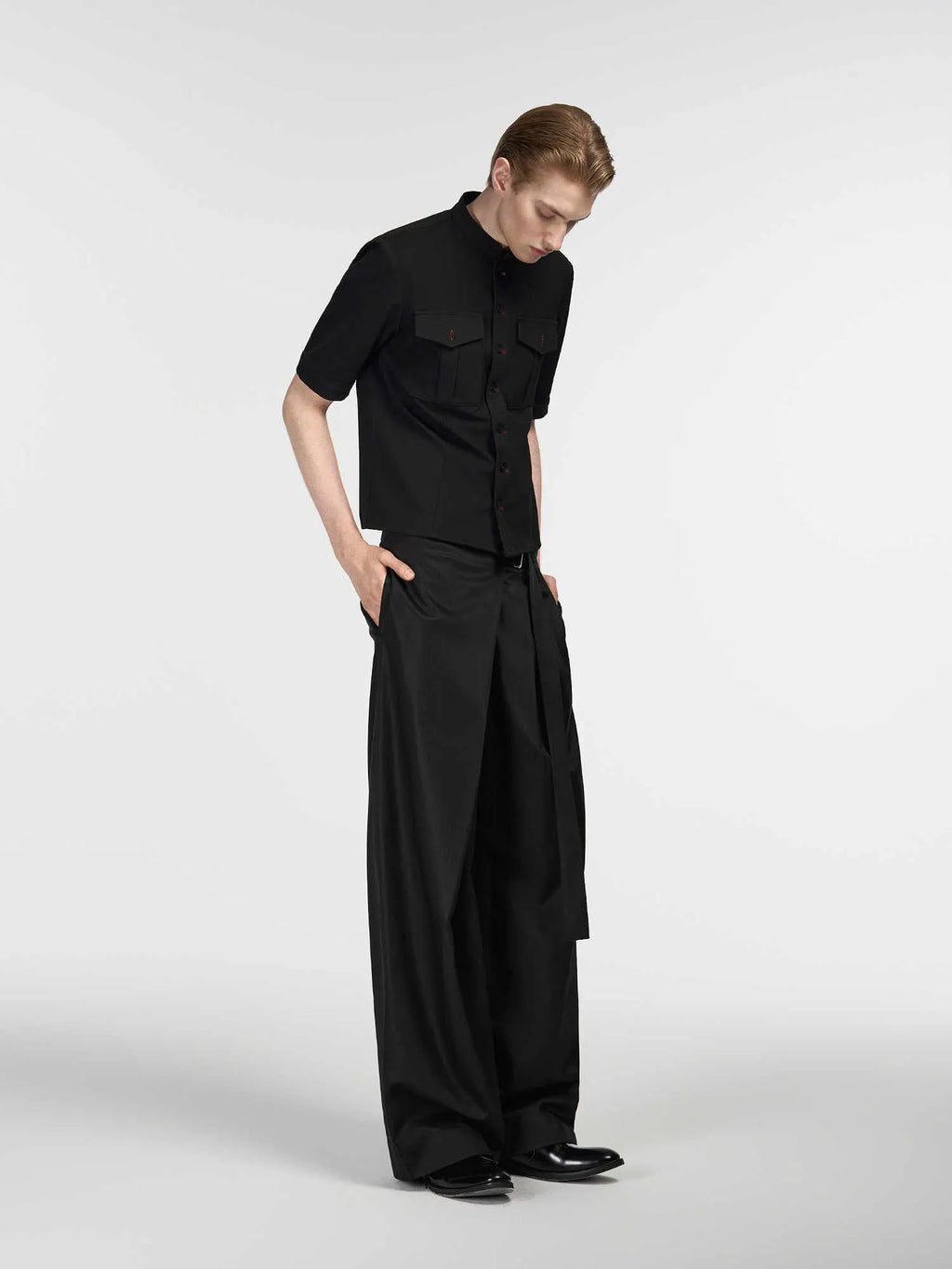 Black loose fit straight-leg trousers with single pleat front and adjustable waistband