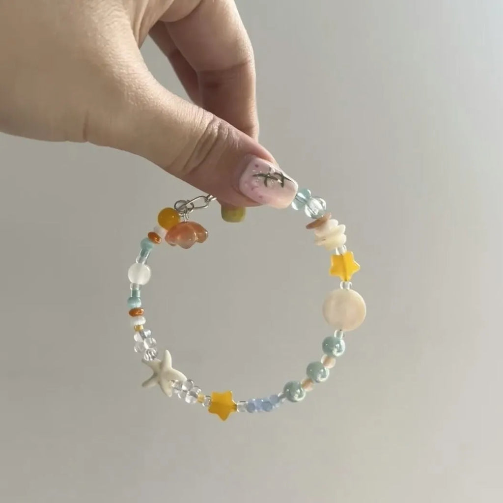Orange women's bracelet with diamond links and round decorative elements on wrist