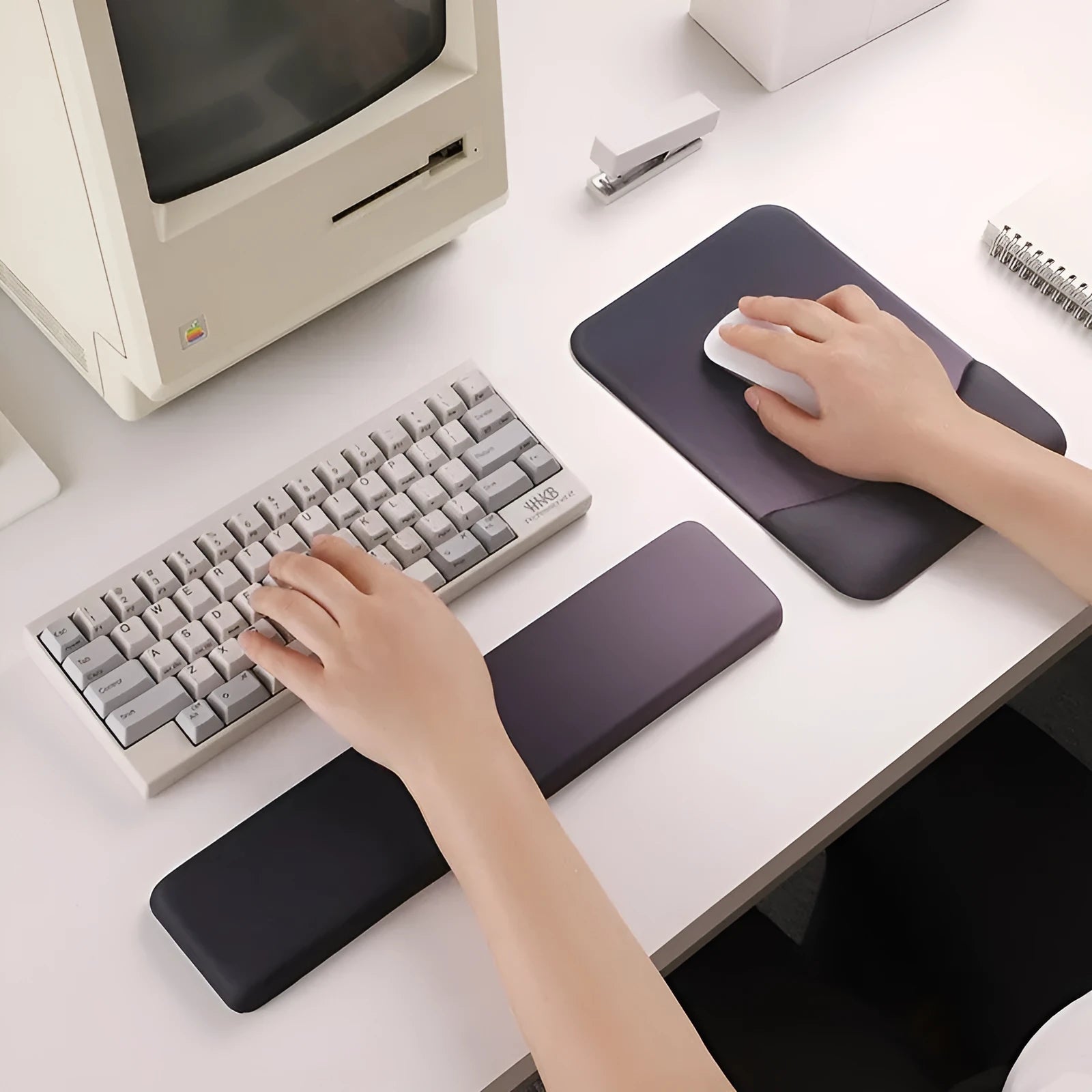 Square cloth wrist rest mouse pad with hand pillow in purple on a desk