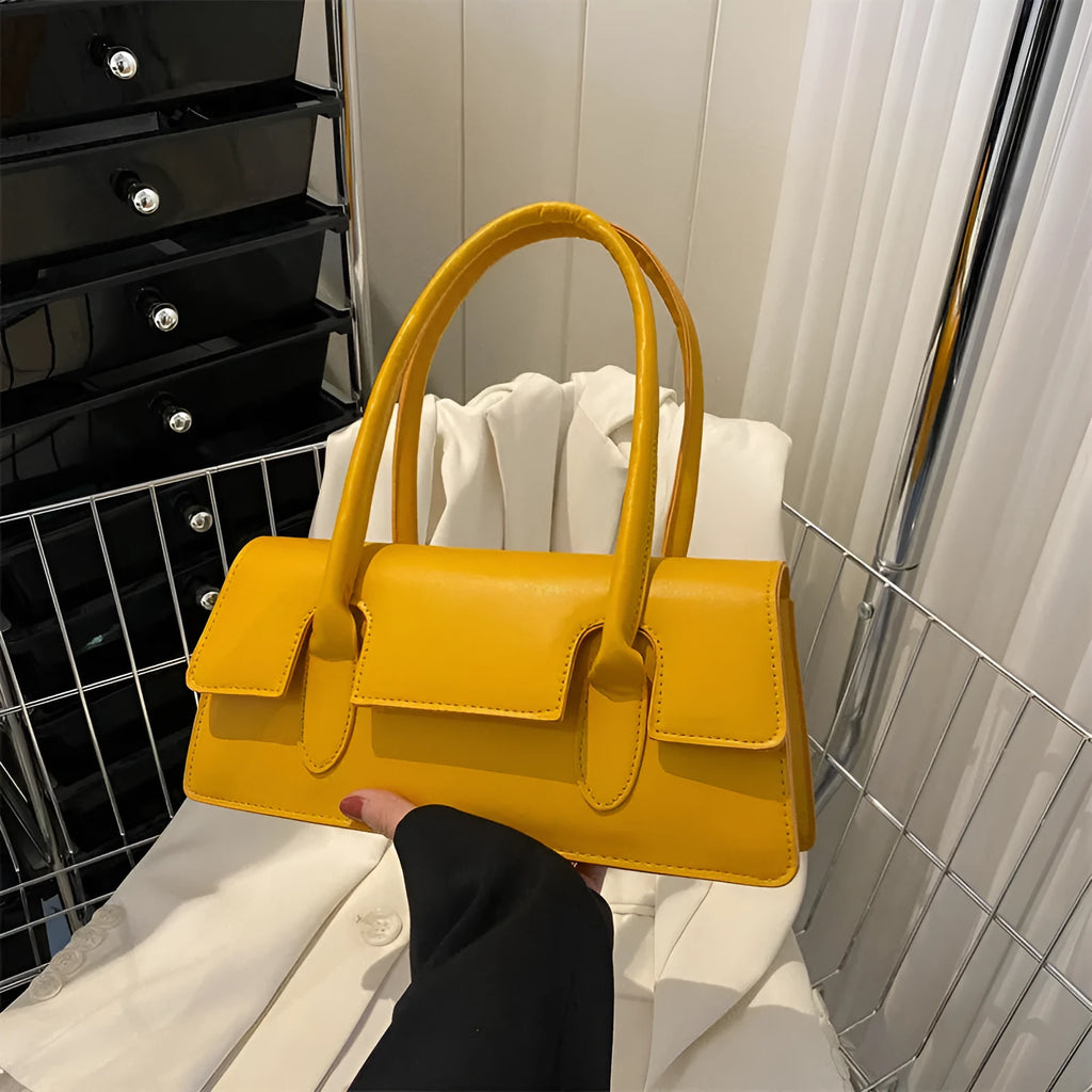 Women's small square shoulder bag in PU leather showing document compartment interior and stitching detail