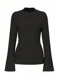 A man's black long sleeve top with a round neck and relaxed lantern sleeves in a slim fit.