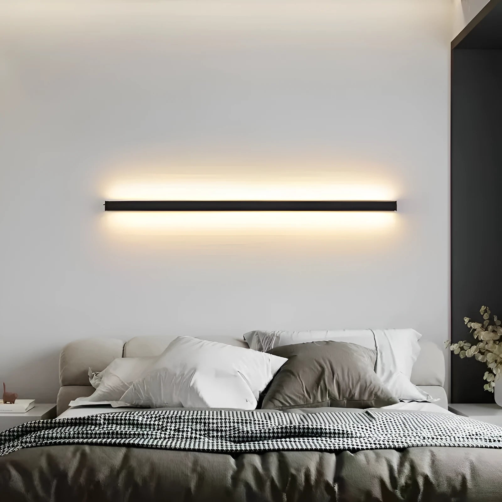 80cm long black aluminium LED wall lamp with touch control for three light colours on a white wall.