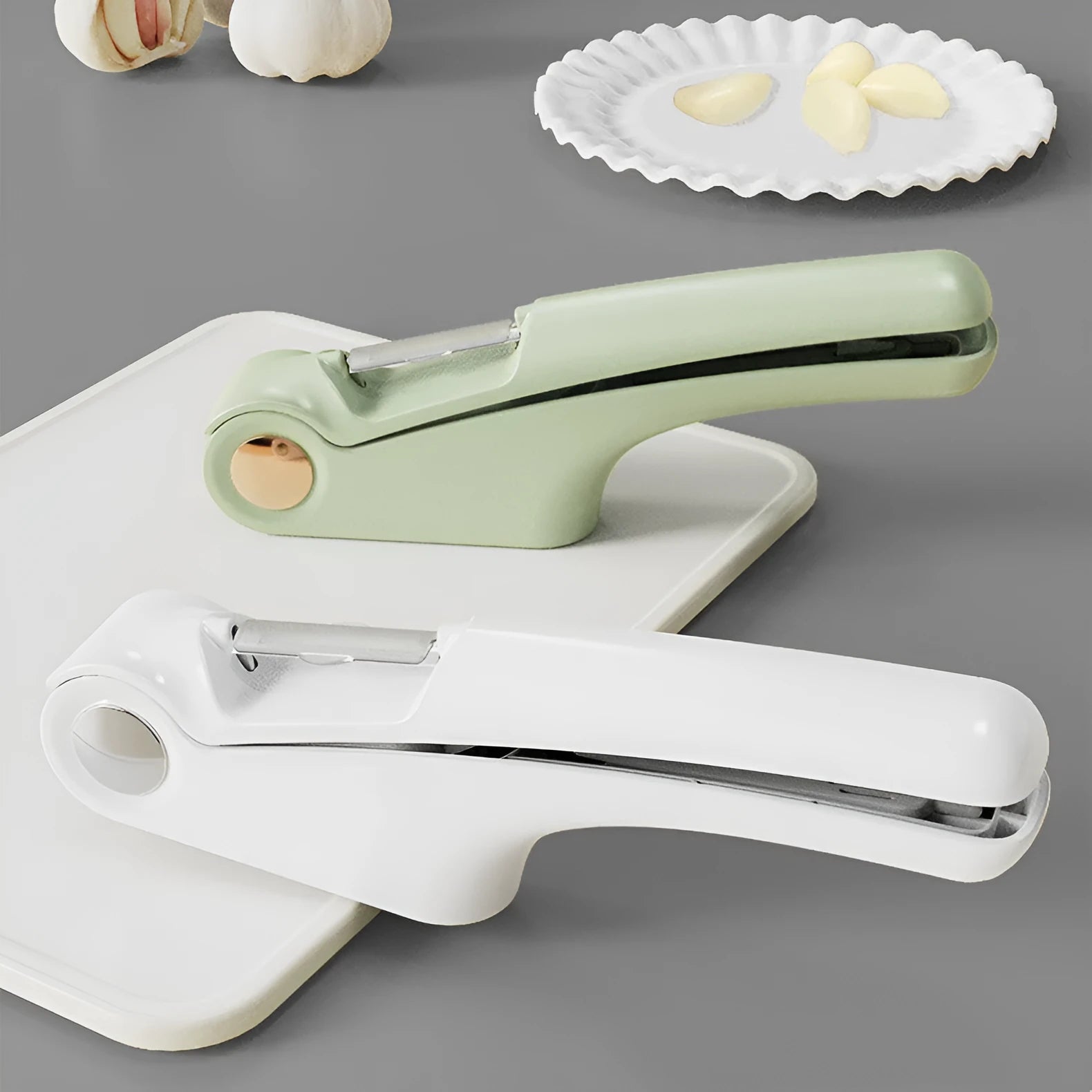 Manual garlic press kitchen tool with stainless steel crusher and coloured ABS handle