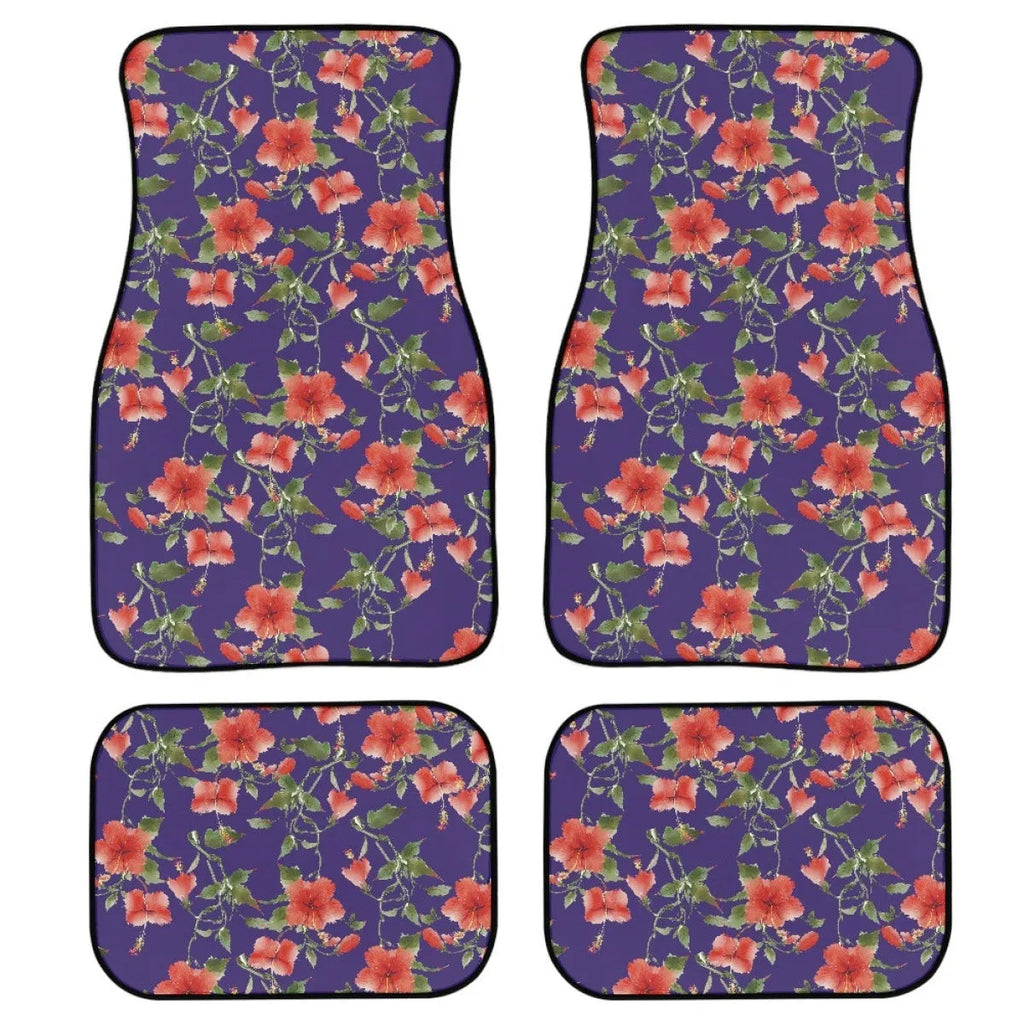 Set of four black printed rubber car floor mats with textured surface, showing thickness.