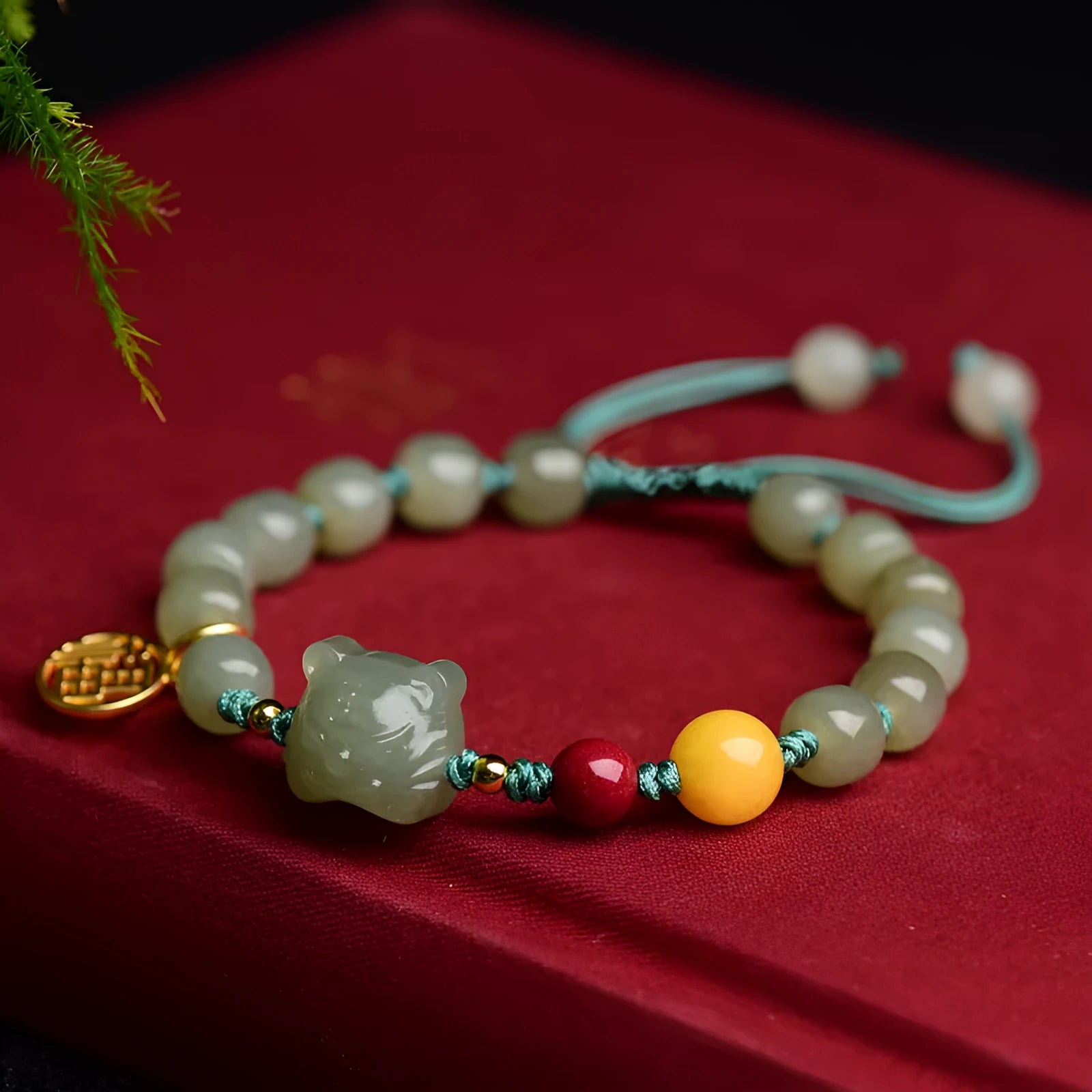 Natural Hetian jade bracelet with zodiac modelling, cinnabar and beeswax beads, and sequin detail.