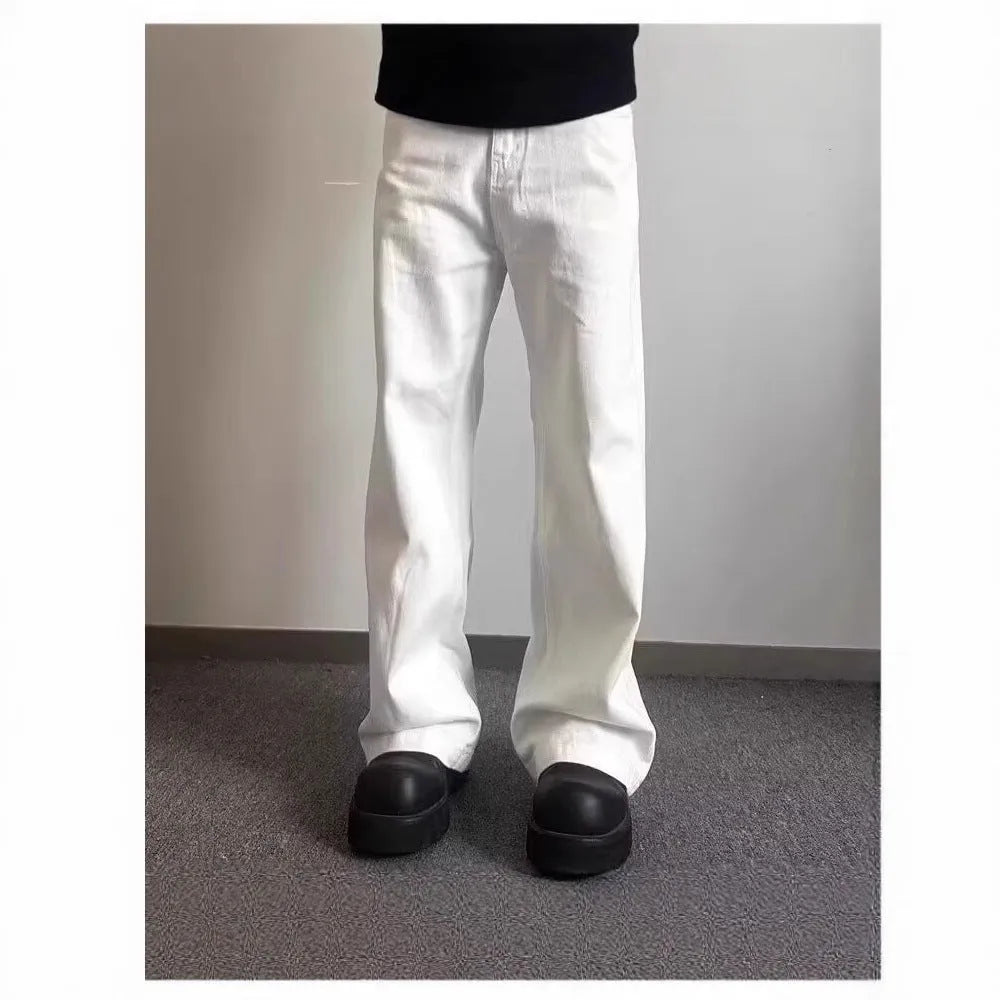 Men's straight leg white denim jeans with a mid waist and wide leg opening.