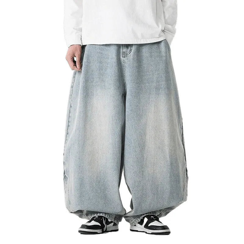 Men's plus size baggy blue denim jeans with a straight leg and low waist on a hanger.