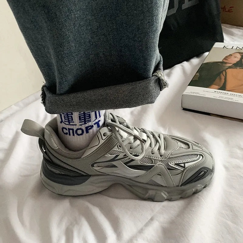 Casual breathable sports shoes with a lace-up front, round toe, and rubber sole in a solid colour.