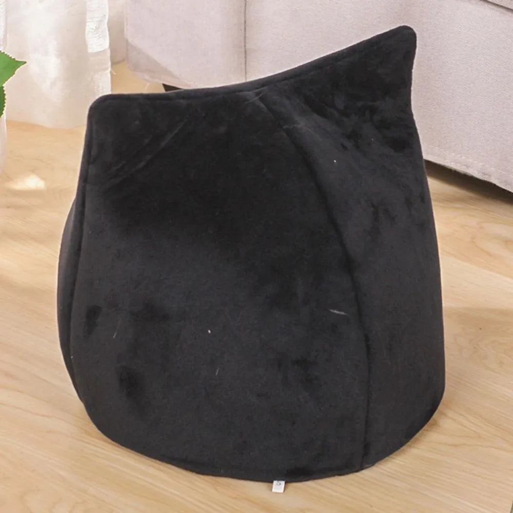 Enclosed cat-shaped pet bed with plush fabric and covered cave design
