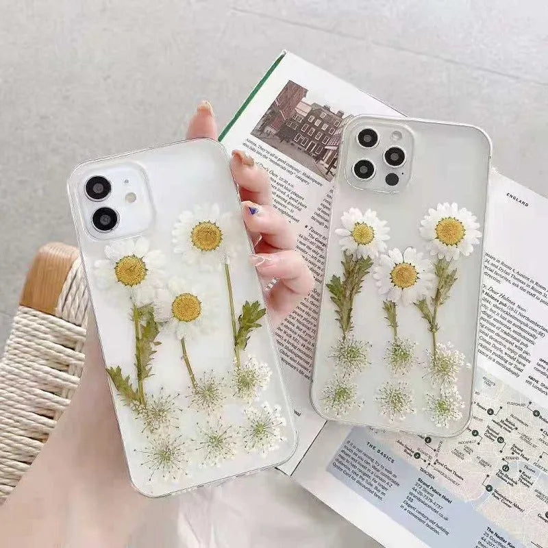 White TPU iPhone case with epoxy daisy floral pattern on back, shown on iPhone model