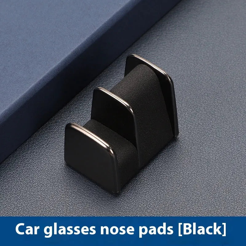 Zinc alloy and leather glasses clip for car dashboard in black, grey, green, or red.