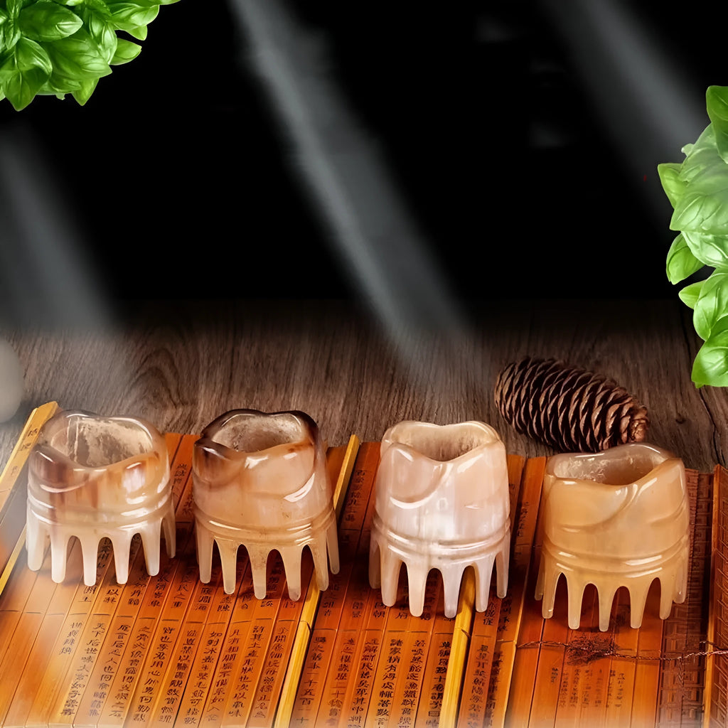 White buffalo horn massage comb with wide teeth and pointed tip for scalp acupressure.