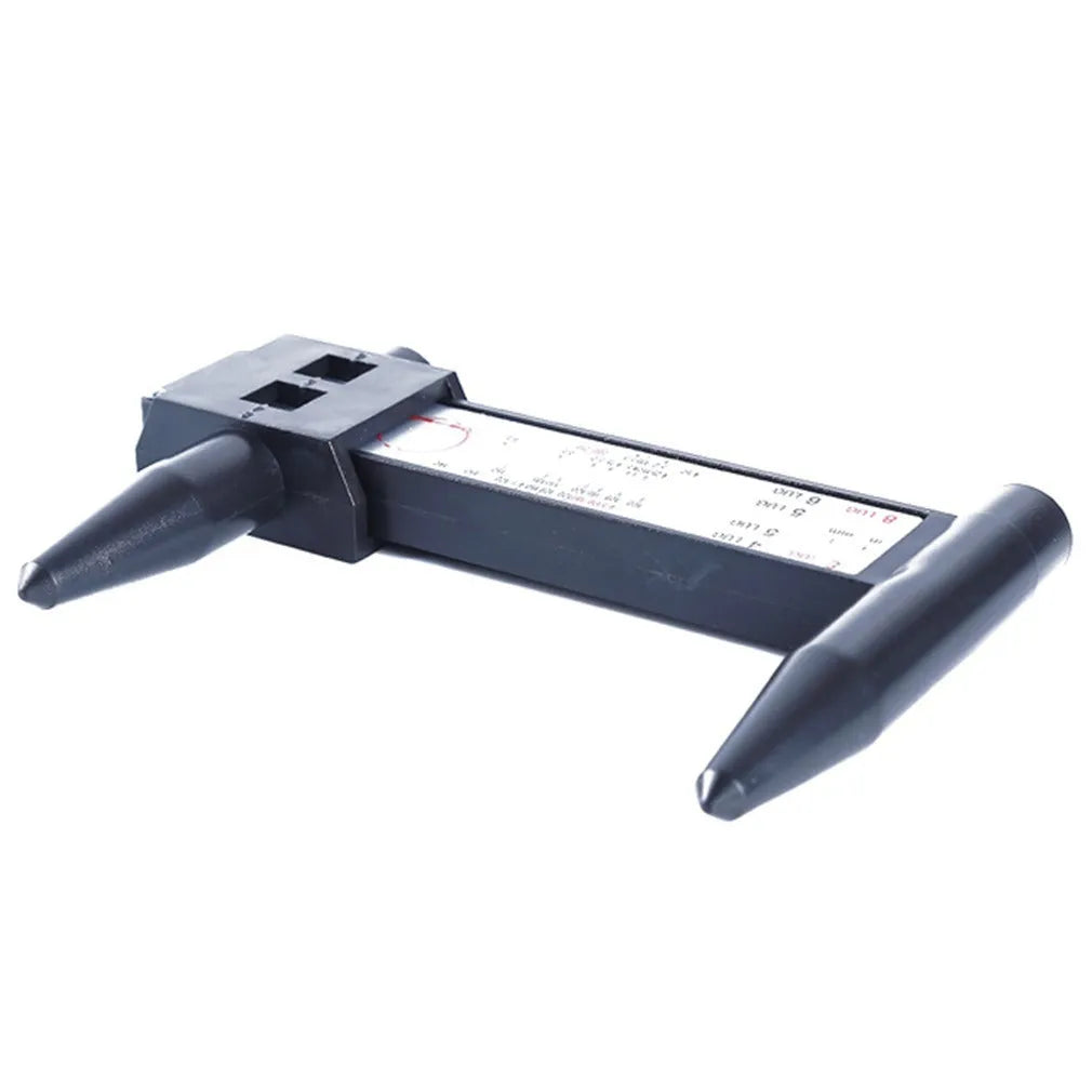 Plastic electronic digital caliper hole distance measuring tool with digital display on a work surface.