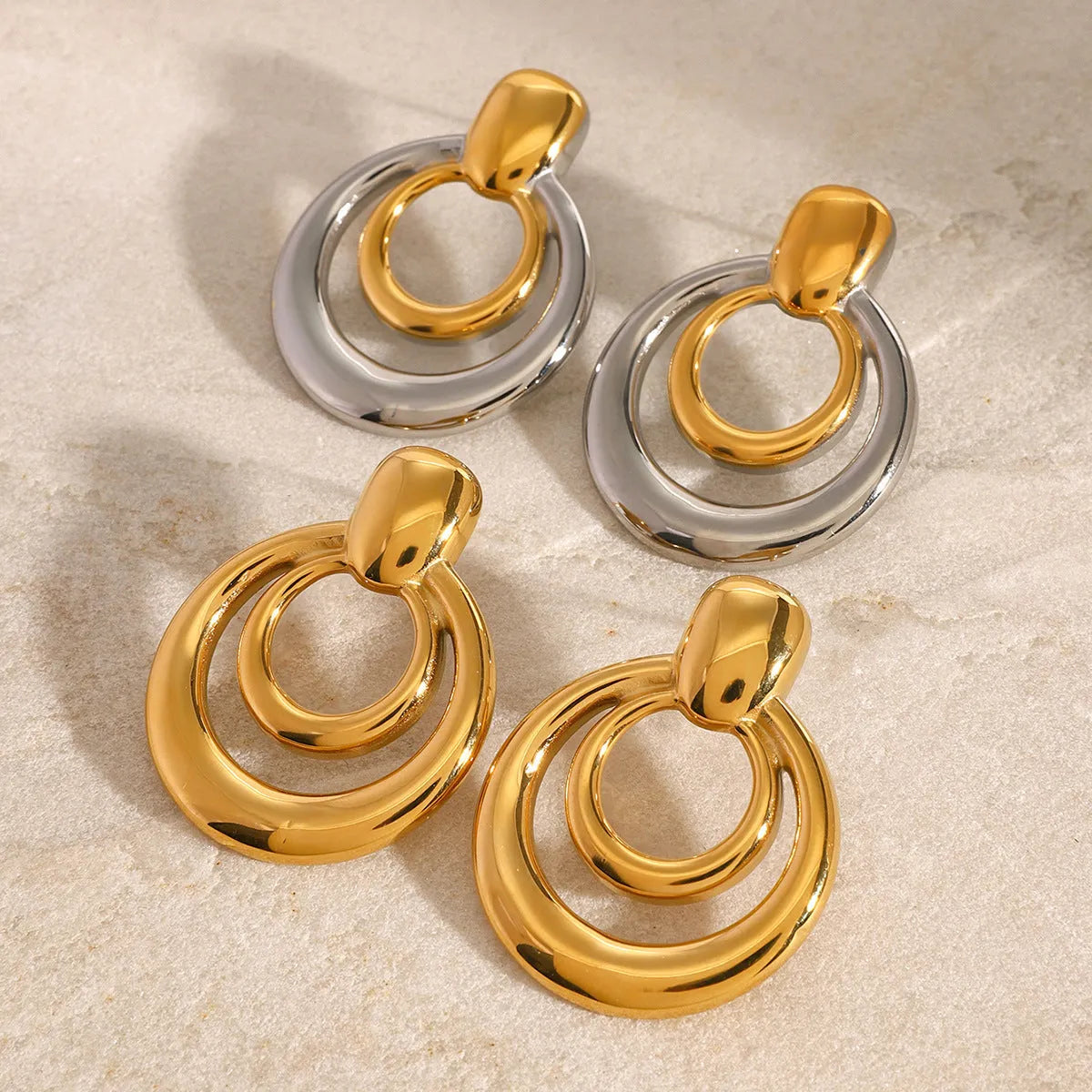 Golden round double-layer hollow stud earrings with 18K gold plating on titanium steel