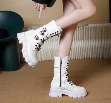Women's black mid-calf knight boots with a large metal buckle and side zipper detail.