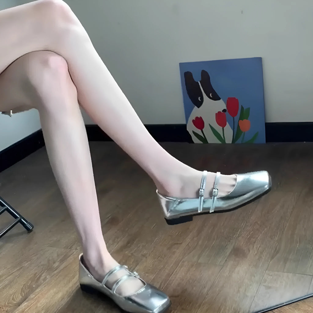 Women's silver genuine leather Mary Jane flats with a cross buckle strap and low flat heel.