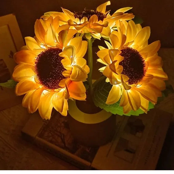 Rechargeable sunflower LED night light with artificial flower design on table