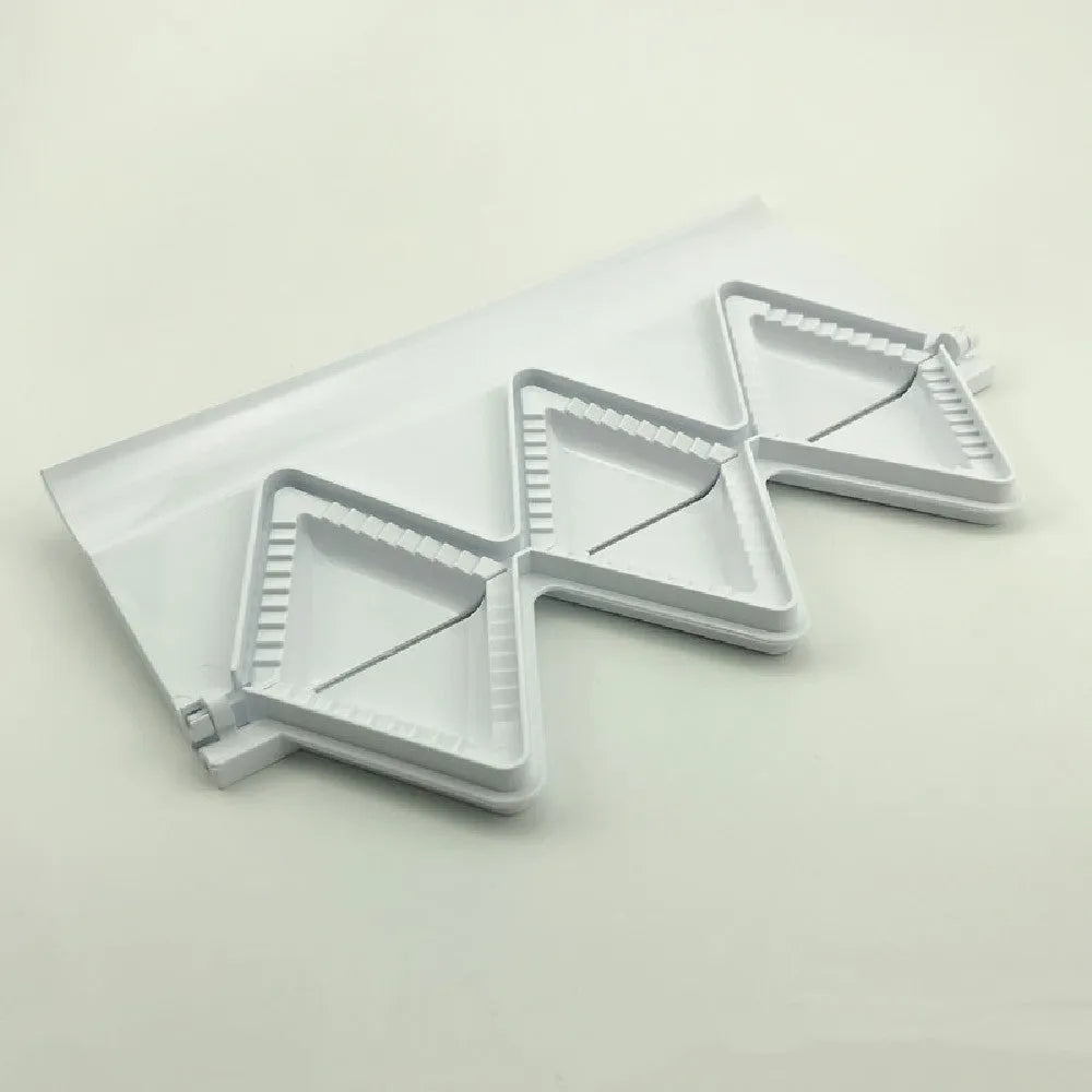 Pure white plastic dumpling maker 28.5 cm long on a kitchen countertop