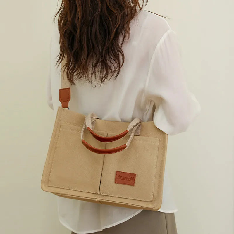 Large casual canvas tote shoulder bag for women with multiple pockets in creamy white