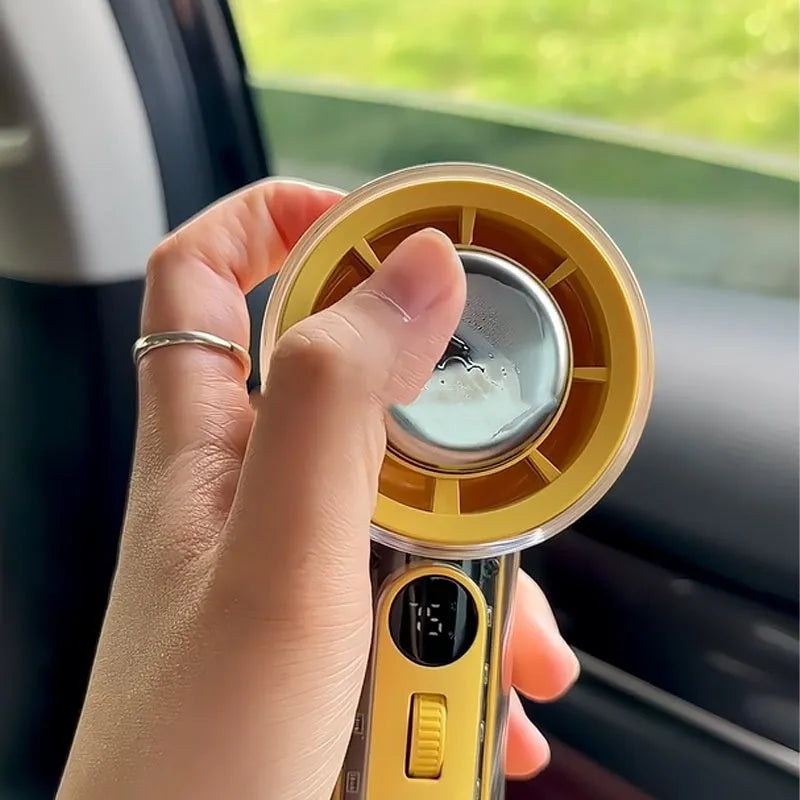 Small yellow handheld fan with refrigeration ice compress function on a table