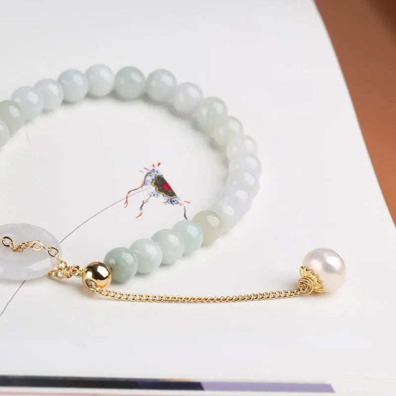 Natural jade bracelet with geometric shape, round pendant, and peace buckle closure on a wrist.