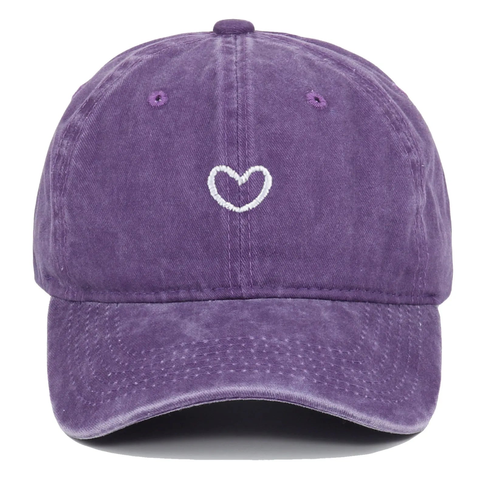 Adjustable cotton baseball cap featuring a distressed embroidered love heart on the front, shown in a selection of colours.
