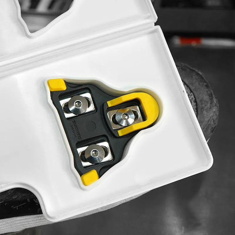 Locking plate adjustment tool for SPD and KEO bicycle pedals on a workshop bench.