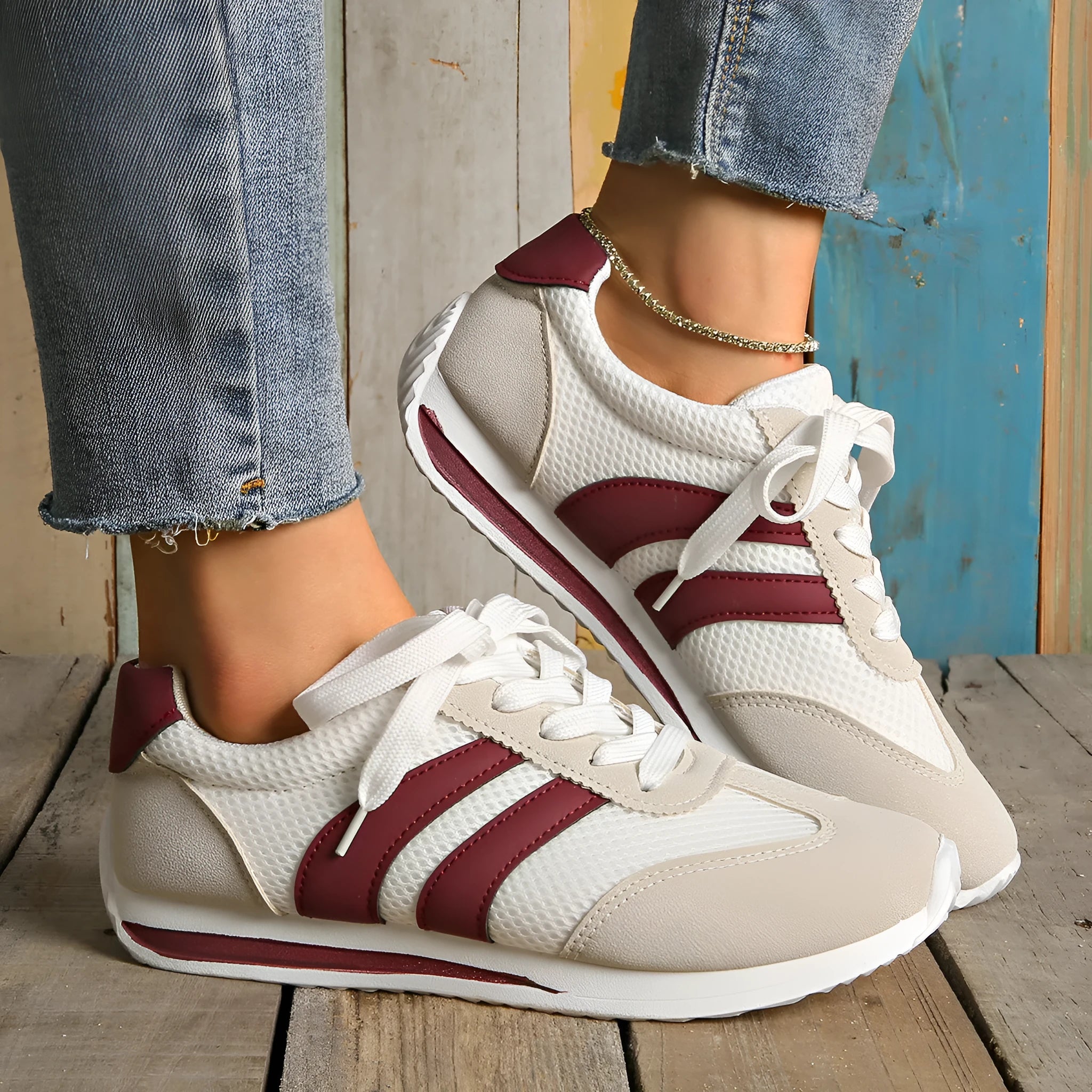 Wine red Cortez Retro low-top sneakers with a cross-strap and breathable mesh panels.