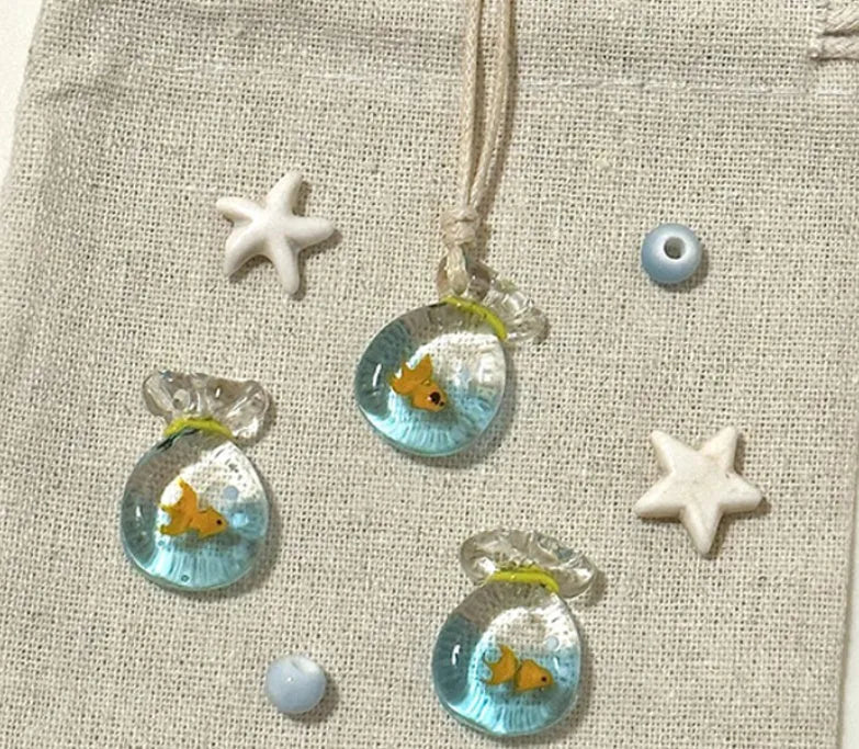 Women's necklace with coloured glaze joker charm on a cotton and linen clavicle chain