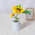Rechargeable sunflower LED night light with artificial flower design on table