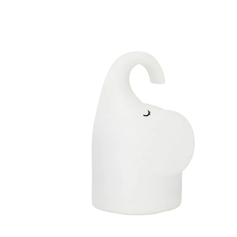 DOMI elephant-shaped silicone night light in warm white, showing its compact size.