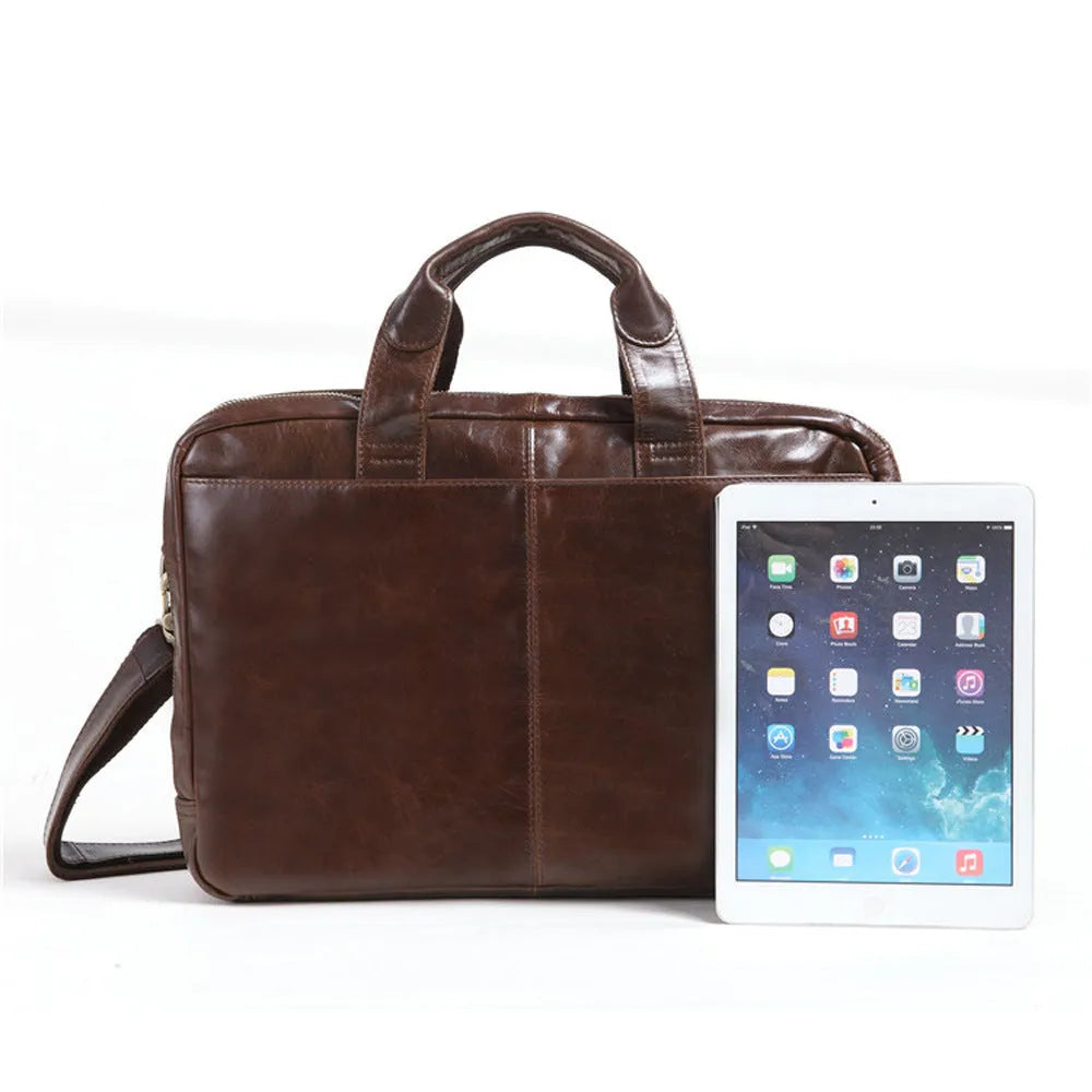 Brown cowhide leather business briefcase open showing interior polyester cotton lining and 18-inch laptop storage