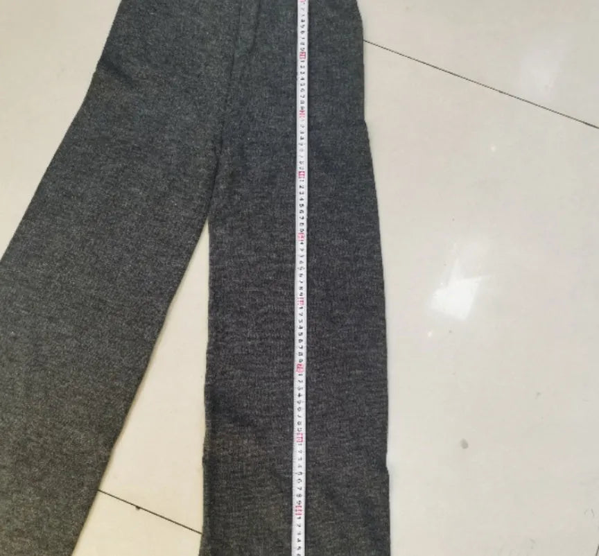 Women's solid colour acrylic sweater and trousers suit set with a side-slit top design.