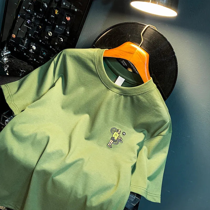 Green men's loose fit printed short sleeve t-shirt on a hanger