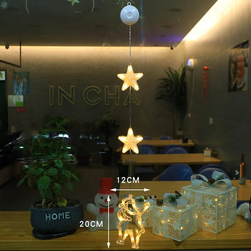 Three Christmas LED light ornaments with suction cups hanging on window