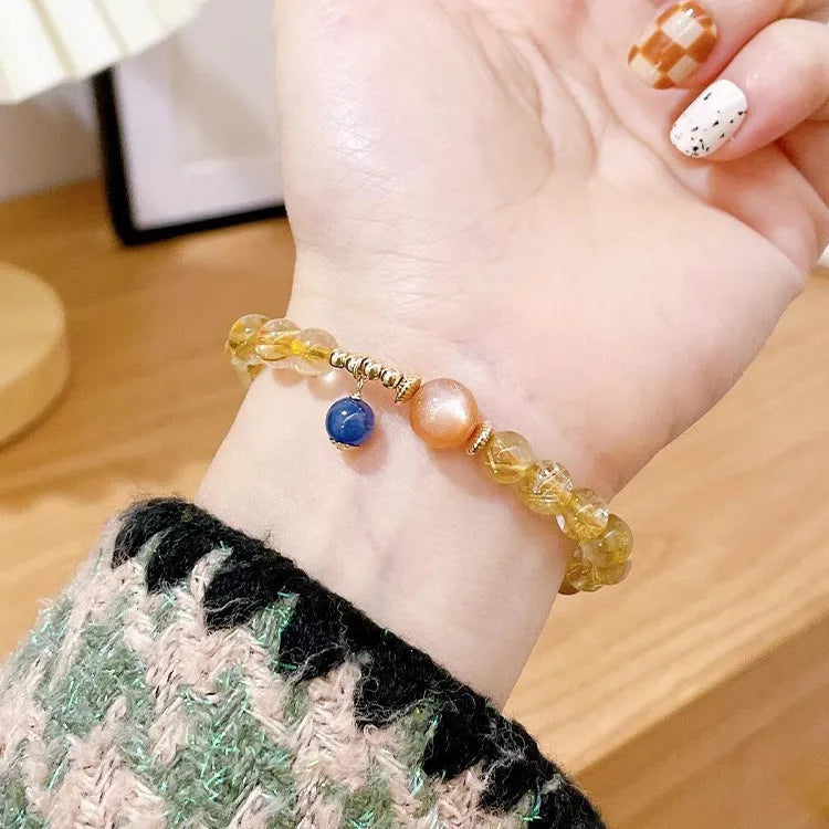 Gold rutilated quartz sunstone crystal bracelet with diamond-shaped beads for women.