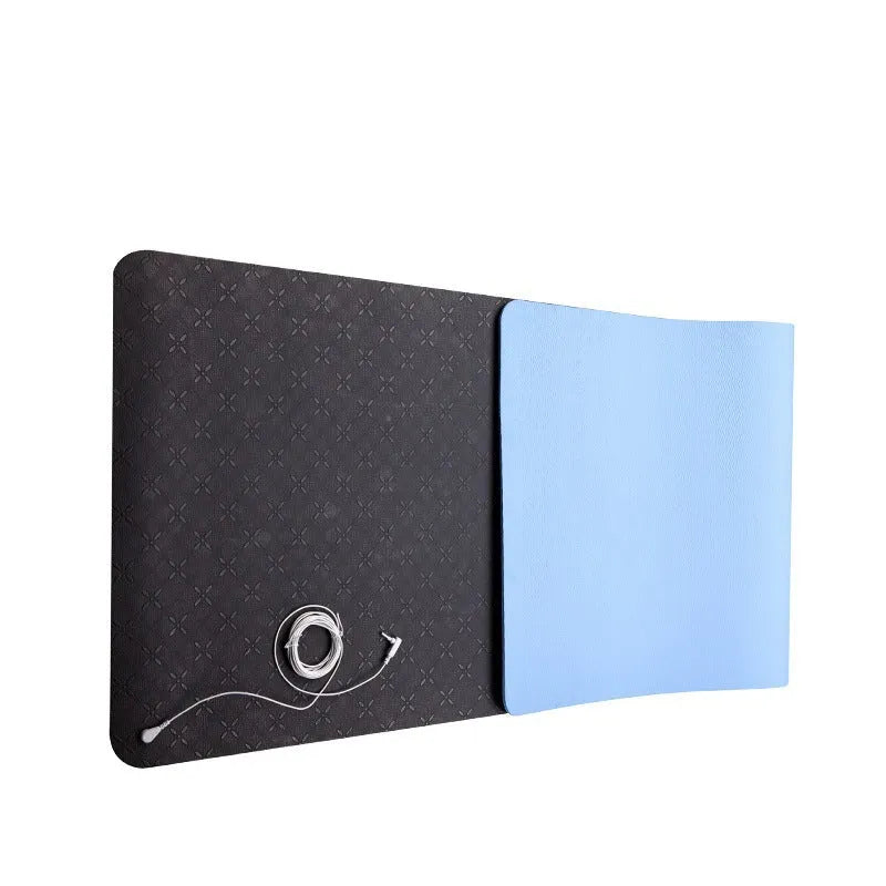 Blue yoga mat with plant patterns, showing grounding wire and non-slip texture.